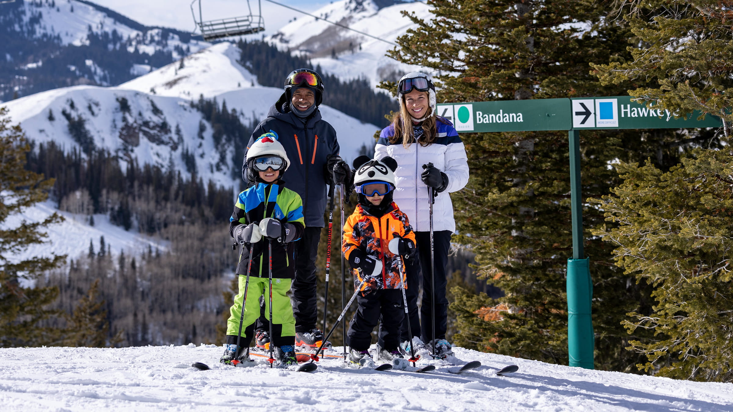family of four standing by Bandana ski run