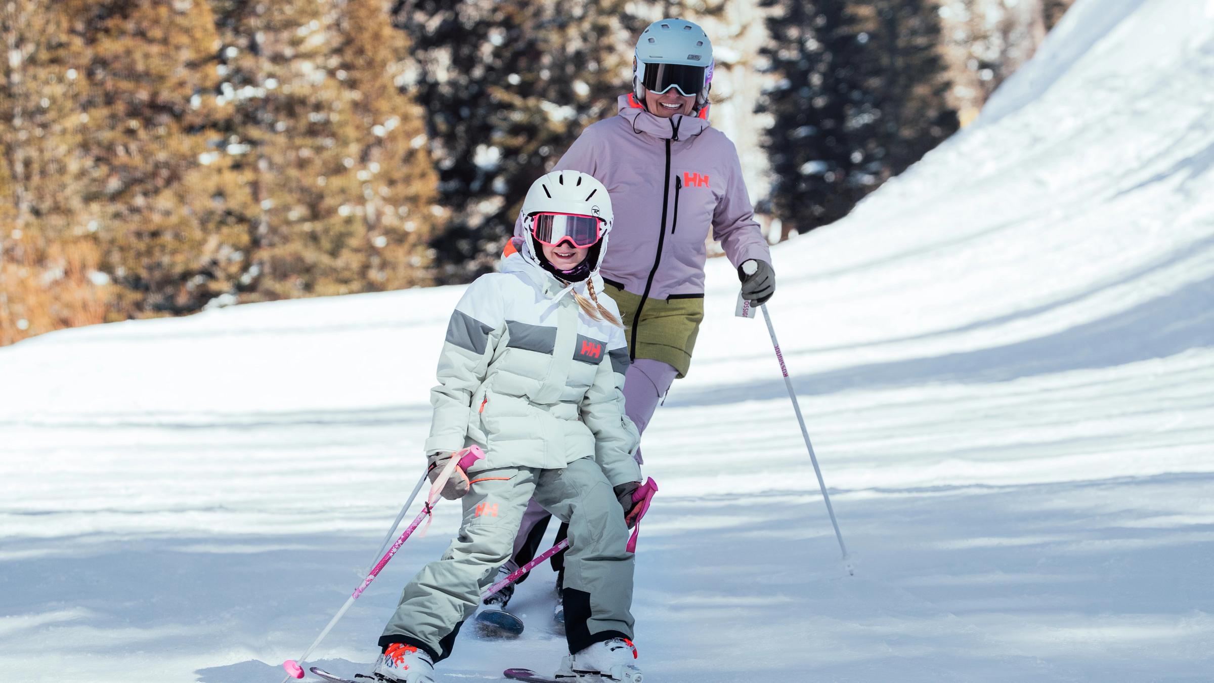 Mother and daughter skiing in Helly Hansen
